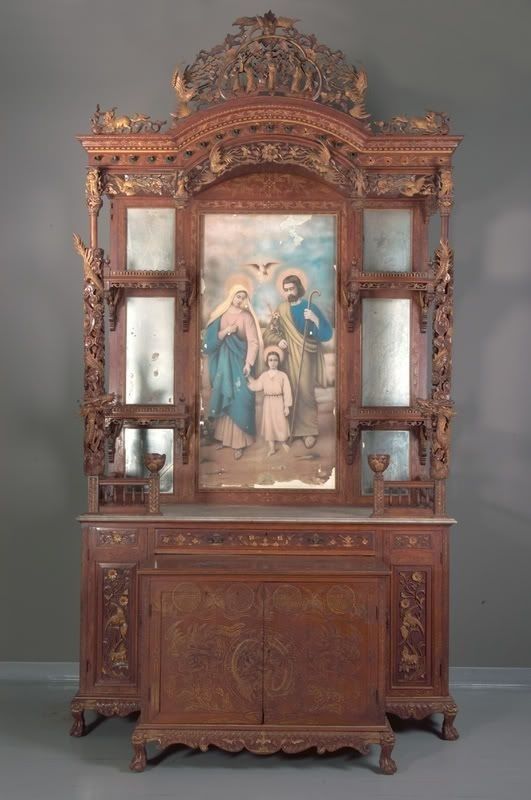 There are businesses that will enlarge a favourite print of yours into the dimensions that you require. This beautiful image of the Holy Family makes a beautiful home altar. You can copy this look with wall placement of prints, statuary on small shelves, candles, and silk flowers.